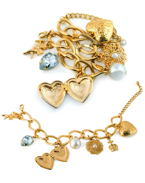 Gold jewelry including charm bracelets and heart lockets